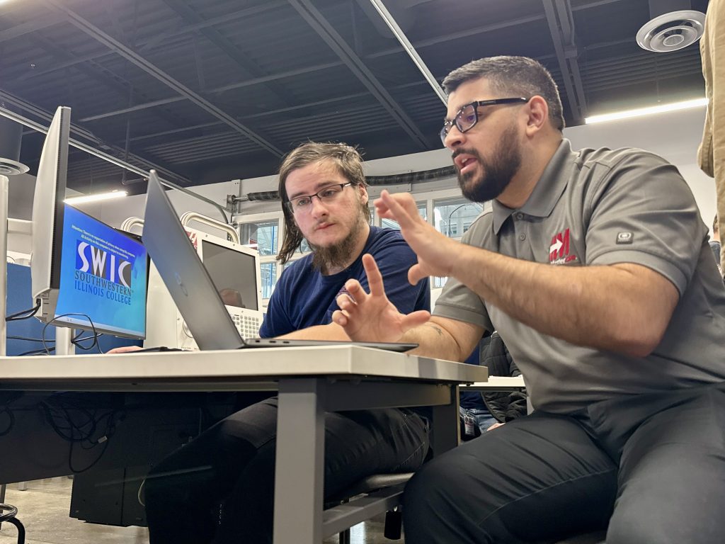 An ACE Mastercam bootcamp student works through the software with Mastercam Content Developer Matt Siehl.