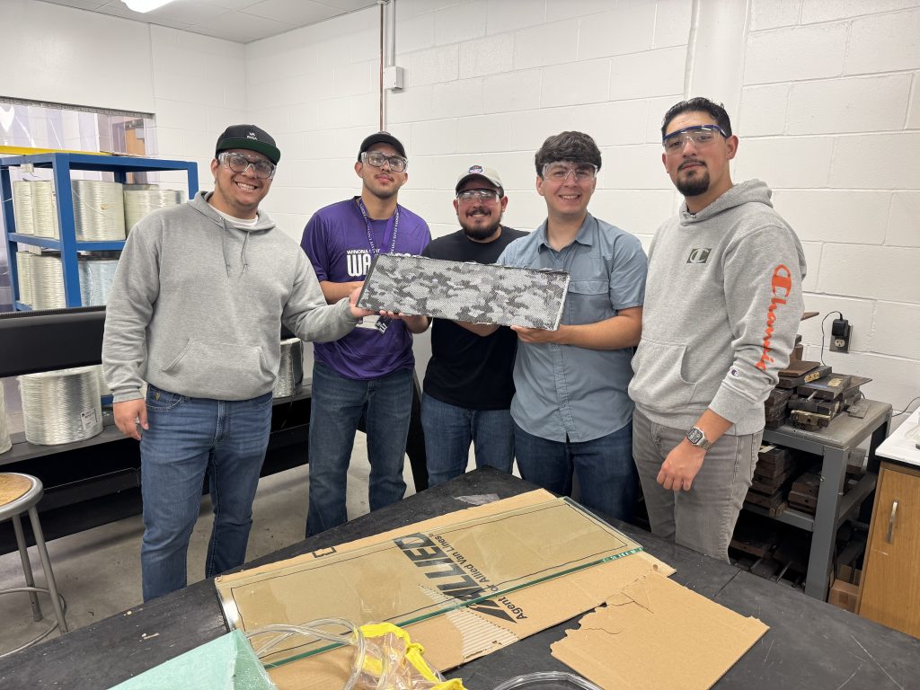 Five UTRGV students hold up a composite panel.