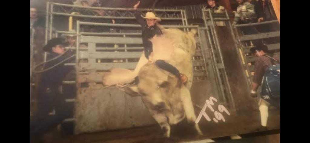 Justin Maples riding a bull.