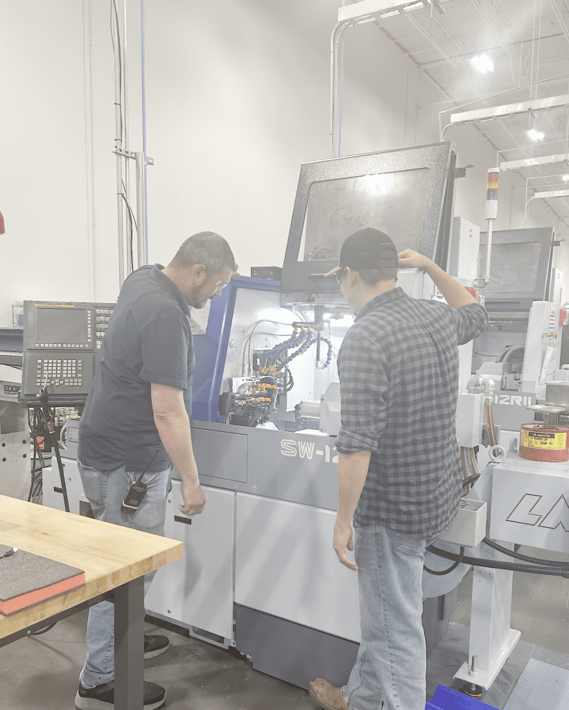 Zachary looks inside a CNC machine.