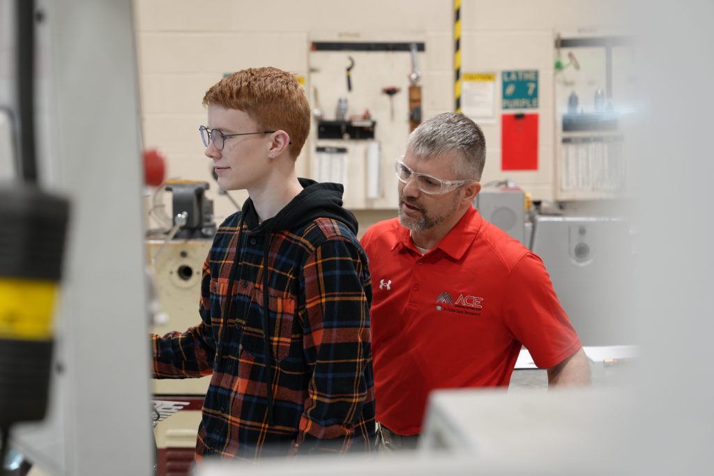 Nick Rowland works with Connor Anderson on a CNC machine