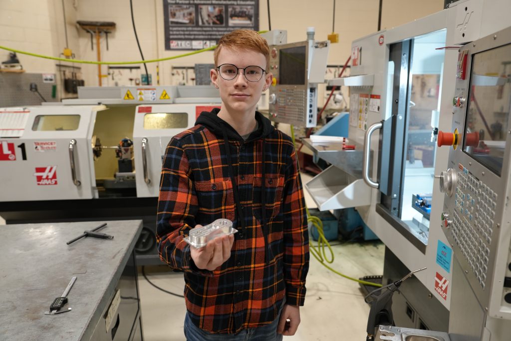 Connor Anderson holds an ACE air engine